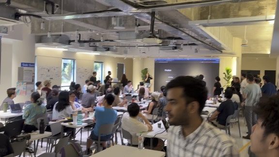 Crowd gathered for demo presentations at the hackathon