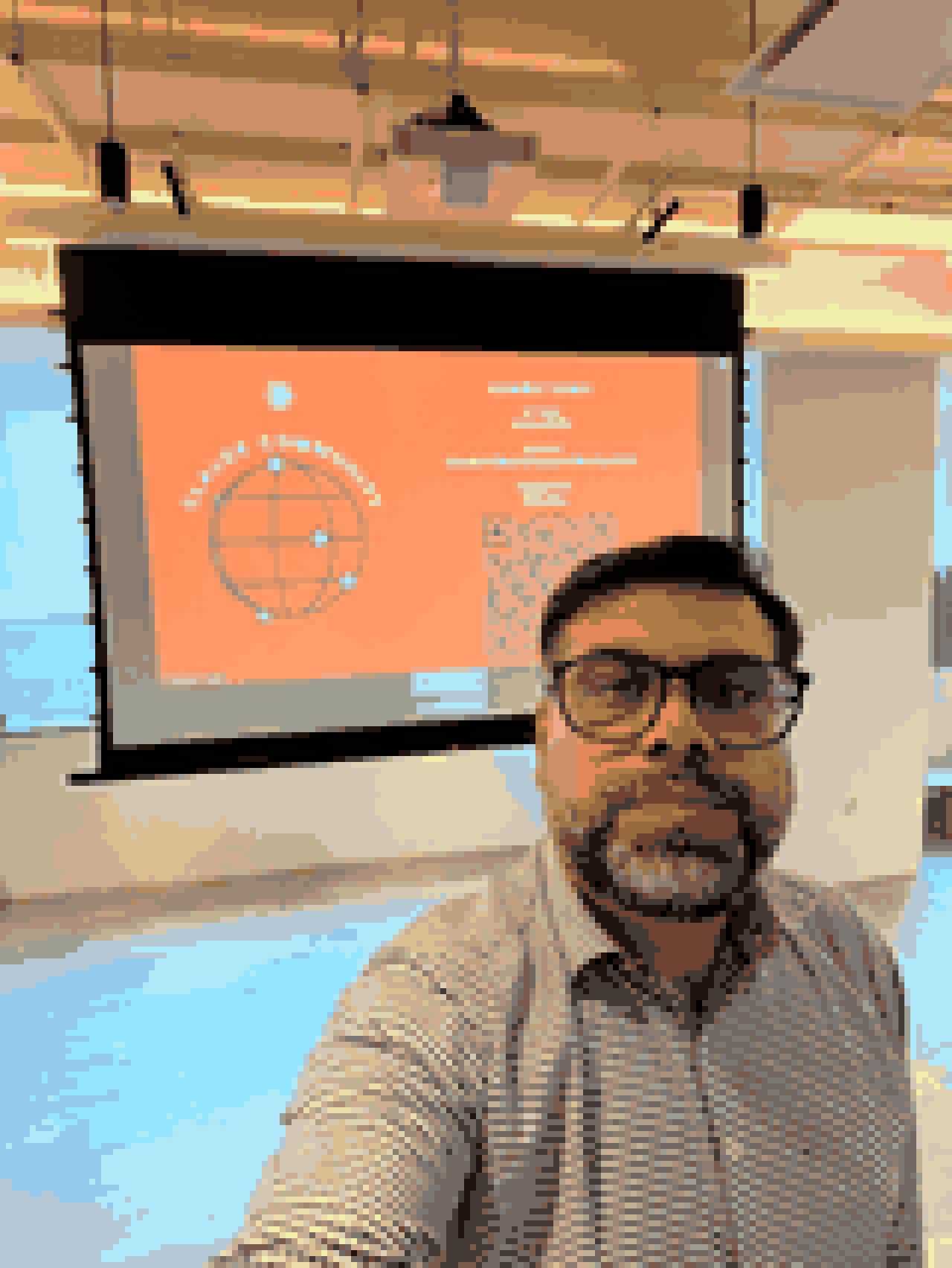 Pixel-art selfie of Tanveer Riaz in the event room, Claude Community slide on the screen behind