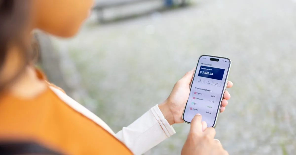 A person checks a bank account balance on a smartphone